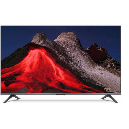 Televisore con schermo piatto che mostra un vulcano attivo con lava rossa e paesaggio montano sullo sfondo.