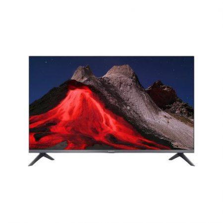 Televisore a schermo piatto con immagine di un vulcano attivo che erutta lava rossa su uno sfondo notturno.